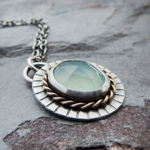 aqua bezel gemstone in gold and silver
