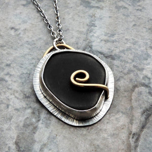contemporary silver black and gold pendant