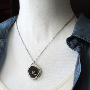 Black Sea Glass Pendant with Brass Prong Swirl