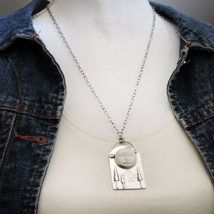 Moon Face Over Mountains and Pine Trees Necklace