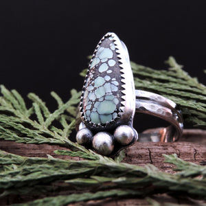 mint green gemstone with black webbing