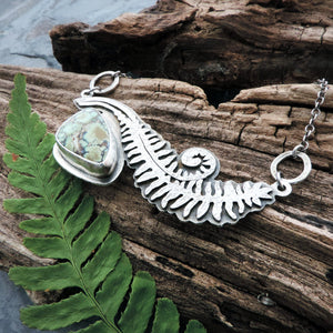 hand cut unfurling fern frond necklace with gemstone