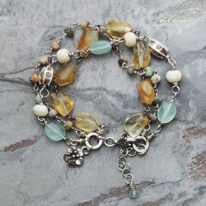yellow aqua triple strand gemstone bracelet with flower
