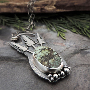 nature inspired jewelry with pine trees and gemstone